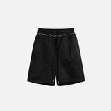 Front view of the black Basic Drawstring Shorts in a gray background 