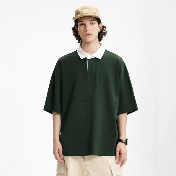 Model wearing the dark green Placket Polo T-Shirt in a gray background