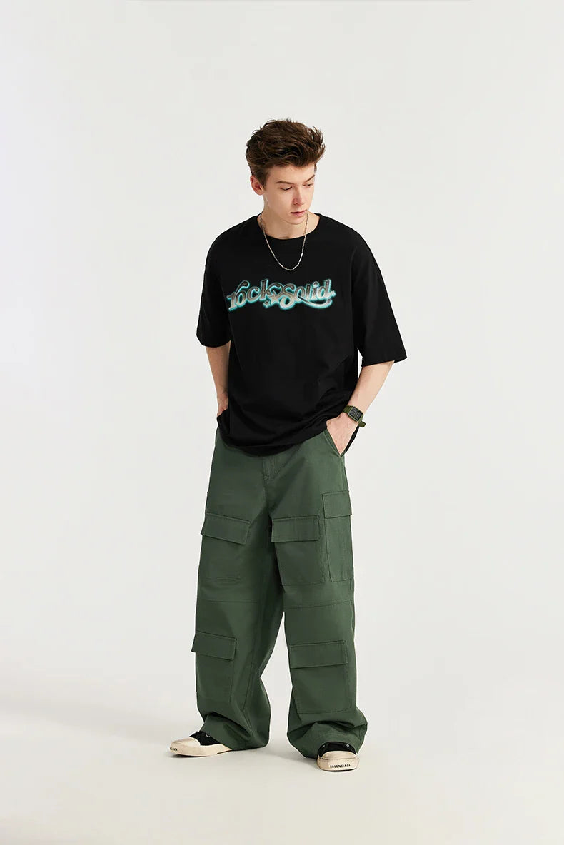 Model wearing the green Trailblazer Baggy Cargo Pants in a gray background