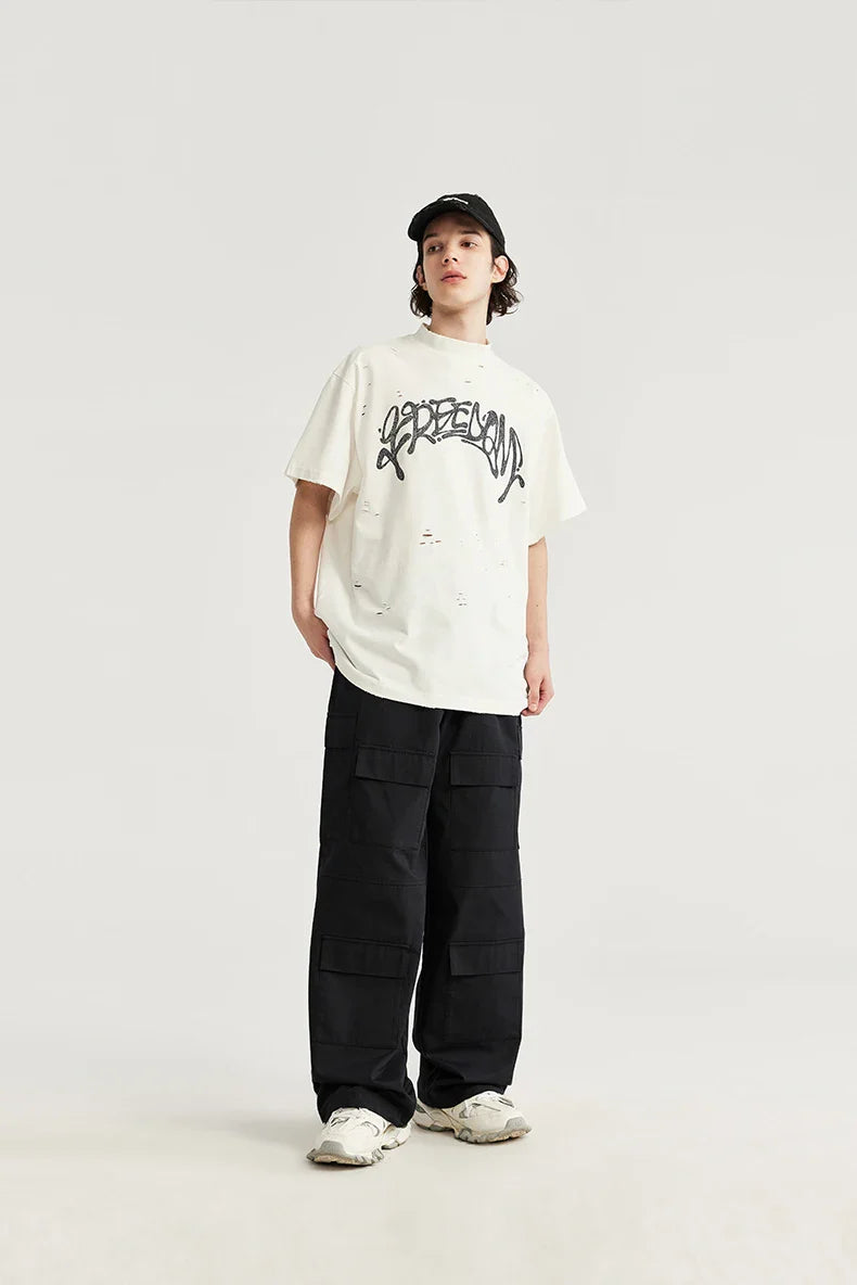 Model wearing the black Trailblazer Baggy Cargo Pants in a gray background