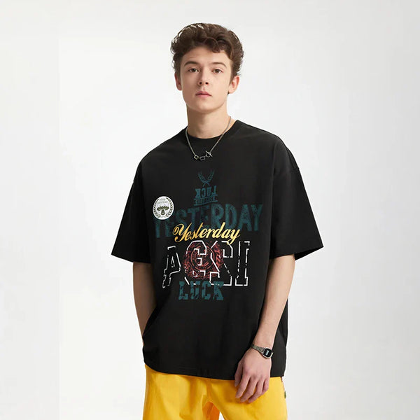 Model wearing the black Style Sphere T-Shirt in a gray background